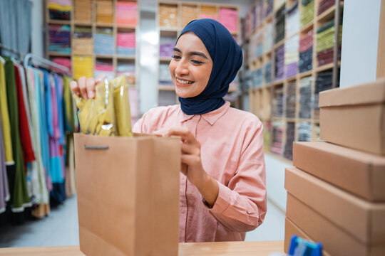 beautiful muslim asian owners are packing the products in boxes prepared for shipping