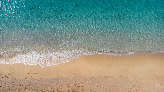 Aerial view of beautiful sandy beach and soft turquoise ocean wave. Tropical sea in summer season on Egremni beach on Lefkada island.