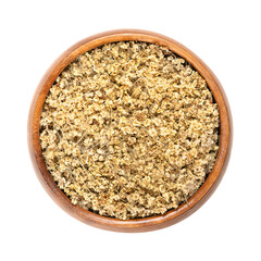 Dried elderberry flowers, in a wooden bowl. Blossoms of Sambucus, also known as black elder or elderflower. Used as tea in traditional medicine. Close-up, from above, isolated over white, macro photo.