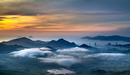 Panoramic photo of dawn viewed from the high mountains, in the distance is the famous coastal tourist city of Nha Trang