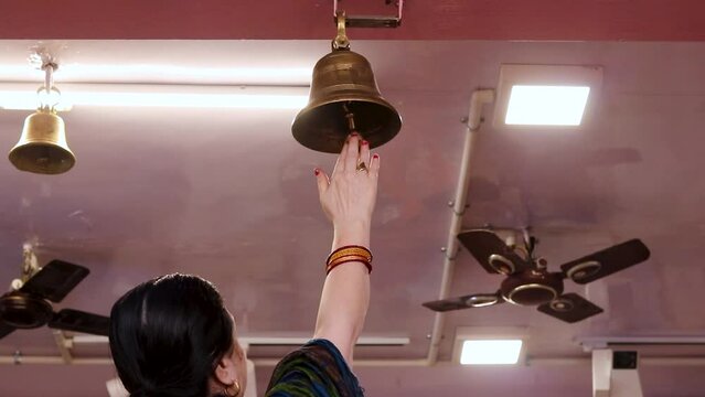 devotee ringing the holly bell at temple at morning