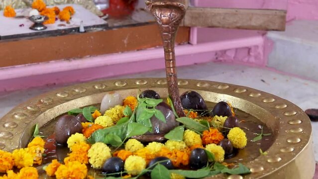 hindu god shiva idol worshiped with flowers at temple from flat angle