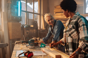 Cheerful female carpenters working.