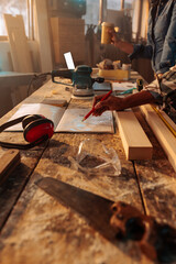 Close up on carpenters studying project blueprint.