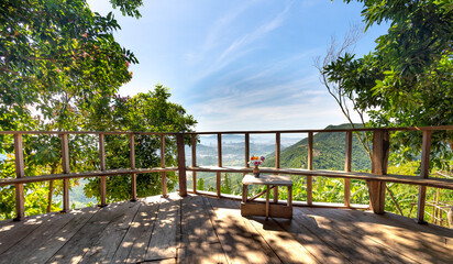 Simple little house with wooden balcony overlooking the valley. In the distance is the coastal city of Nha Trang, Vietnam