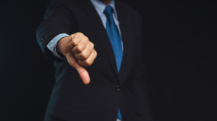 Negative concept. Close-up of businessman's hand showing a thumbs down for dislike service © meeboonstudio