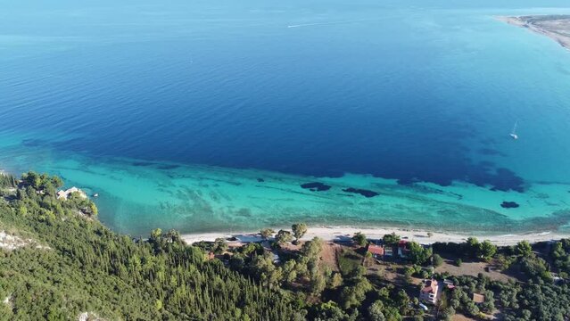 Aerial view of Agios Ioannis beach in Lefkada island in Greece. In front are the olive trees and in distance is mainland.
