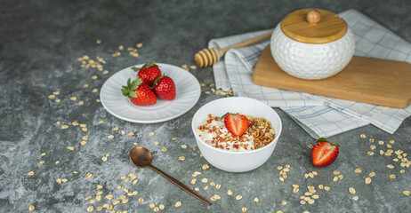 Healthy food concept: homemade granola with yogurt and strawberries. Oatmeal with freeze-dried strawberries, fresh berries and honey. Delicious and healthy breakfasts. Banner, copy space for text
