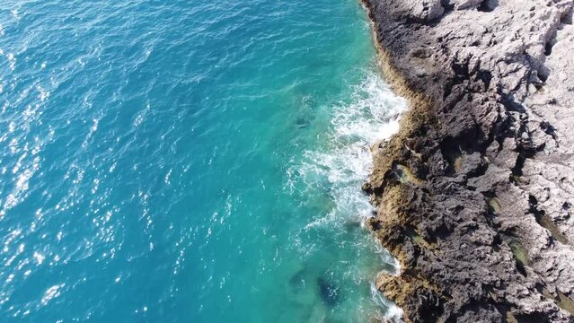 Aerial view of sea hitting the rocks on Porto Katsiki beach. Tropical turquoise sea in summer season on Lefkada island.