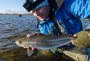 Angler with small but chubby sea trout
