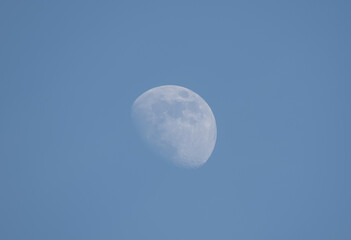 The moon is in the sky with a clear blue sky