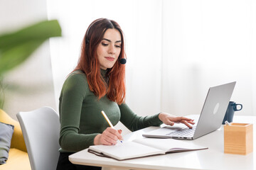 Fototapeta na wymiar Focused woman working on laptop
