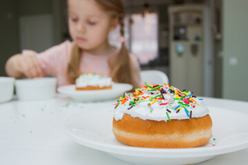 Process of decorating a cake with sweet colored decorations