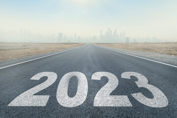 2023 written on highway road in middle of empty asphalt road and beautiful blue sky. Concept for vision new year 2023. future vision 2023