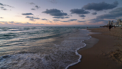 Bat Yam, Israel - August 27, 2020: Sunset over the sandy beach of Mediterranean sea in Tel Aviv