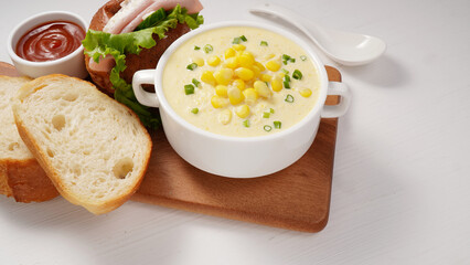 Corn Soup and Bread breakfast menu on white table
