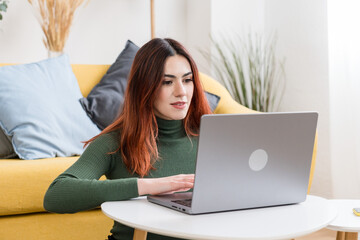 Fototapeta premium Young woman working on laptop