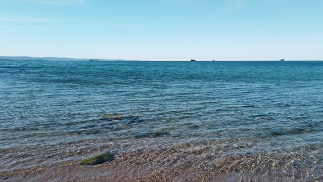Turquoise sea on Barcola seafront in Trieste, Italy, during a windy late winter morning