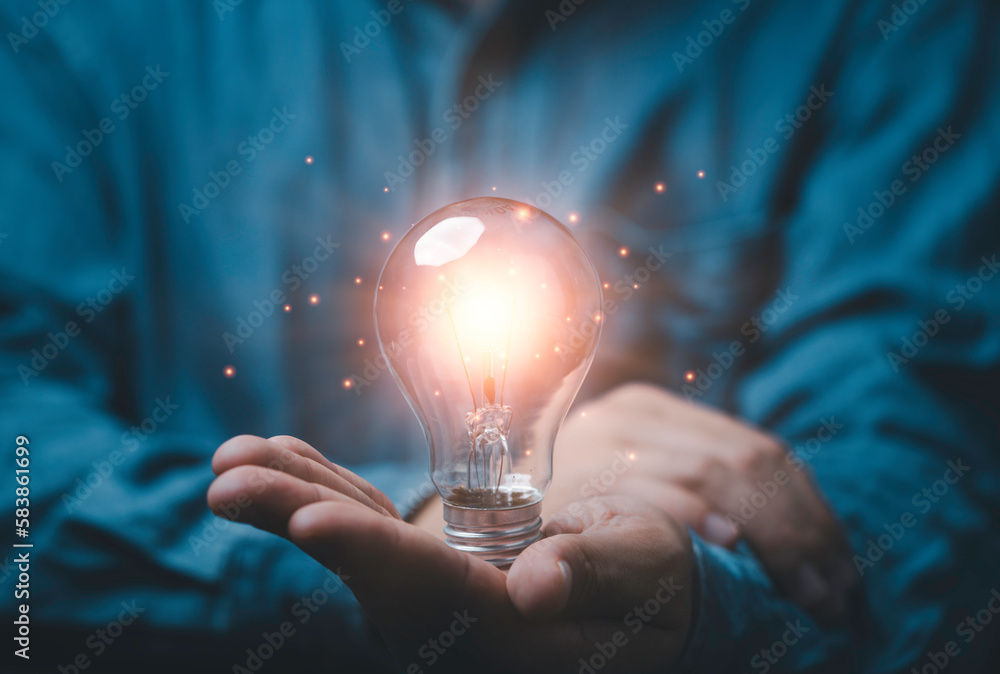 Poster businessman holding glowing lightbulb with copy space for creative thinking idea and problem solving