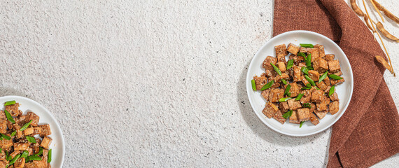 Fried teriyaki Tofu with scallions and sesame seeds. Healthy vegan meatless meal rich in protein