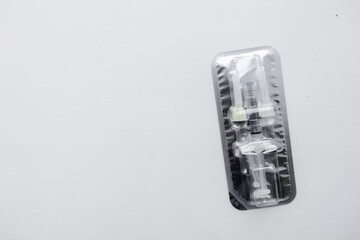 Injection syringe with collagen hyaluronic filler for facial or lip rejuvenation, close-up. syringe and two small needles in an individual package. The filler for the cosmetologist. 