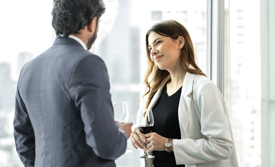 Beard man and beautiful woman drink wine to celebrate love anniversary. Young romantic couple happy dinner in luxury restaurant. Asian woman dating Indian man and have fun drinking alcohol together.