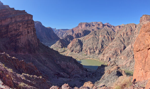 The South Kaibab Trail winding down to the Black Bridge that spans the Colorado River at Grand Canyon with Phantom Ranch just left of center, Arizona