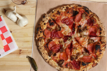 Fresh Pizza on Wooden Table at Restaurant Sliced and Ready to Eat