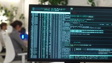 Monitor of computer in modern IT company office with big database code with young successful female and male focused developers coding on computers wearing smart style clothes. - Powered by Adobe