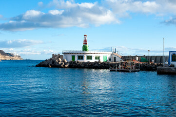Fototapeta na wymiar Small Lighthouse in the port Puerto De Mogan, Gran Canaria, Spain