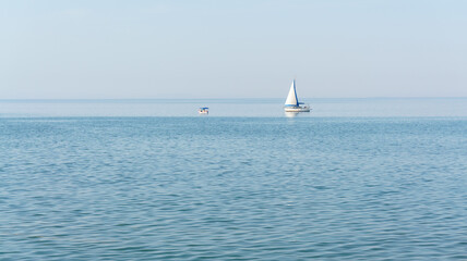 Obraz premium Sailboat on sea with blue clear sky, minimalist concept idea. Blank copy space for advertising texts.