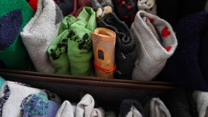 
vacation money in the nightstand with socks