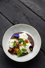 A plate with oatmeal and candied fruits
