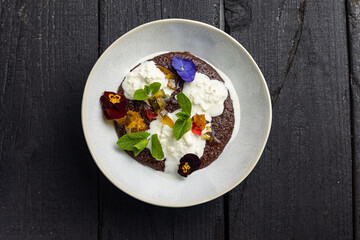 A plate with oatmeal and candied fruits
