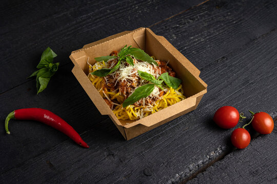 A box of spaghetti with tomato sauce 