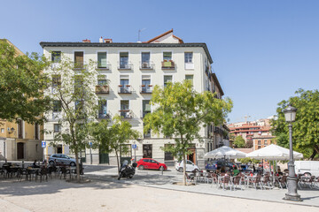 A square in the historic center of Madrid with bar terraces set up with umbrellas