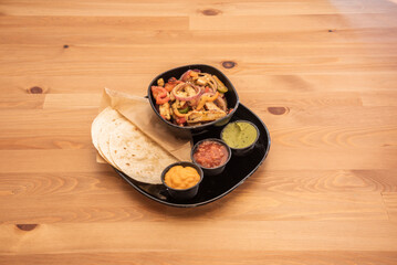 The fajita is one of the most traditional and popular dishes of Tex-Mex cuisine. It consists of meat roasted on the grill and cut into strips, served on a flour tortilla