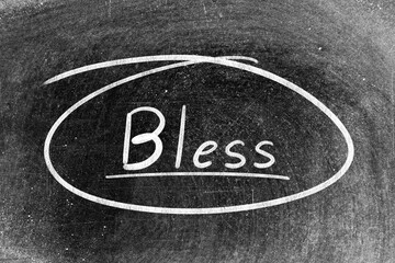 White chalk hand writing in word bless and circle shape on blackboard background