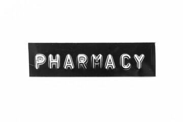 Black color banner that have embossed letter with word pharmacy on white paper background
