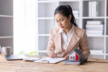 Business woman Real estate broker agent working with home model document presenting and sign...