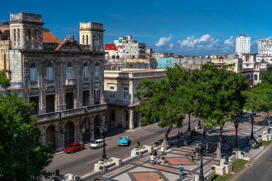 Paseo del Prado, aerial view with promenaders and blue classic car full of tourists, Havana