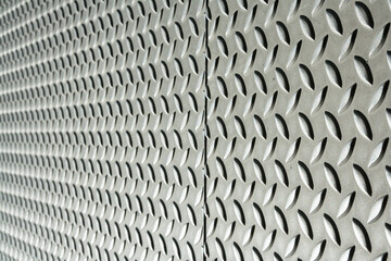 Closeup of metal pattern with diamonds decoration on the wall. Defocused. Horizontal.  