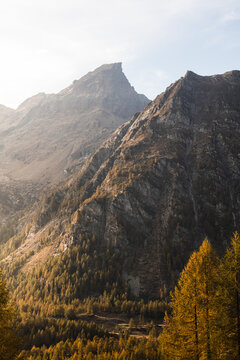 Soft afternoon light shines on the peaks of Alpe Devero, Northern Italy, during autumn