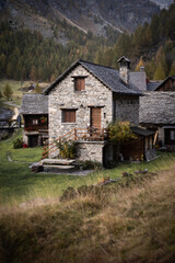 Fototapeta na wymiar A small village of mountains cottages in the middle of the valley of Alpe Devero, Northern Italy