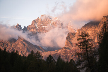 The sunrise appears with beautiful orange tones over the peaks of the mountains of Alpe Devero, Northern Italy