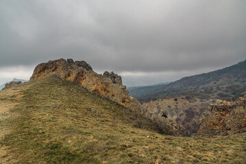 Fototapeta na wymiar Landscape of Karadag Reserve in spring. View of rocks of ridge Karagach. Crimea