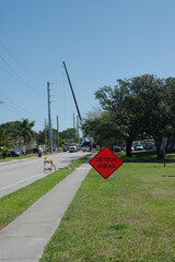 Detour Ahead Sign with Power Poles and Cranes in Background Blue Sky