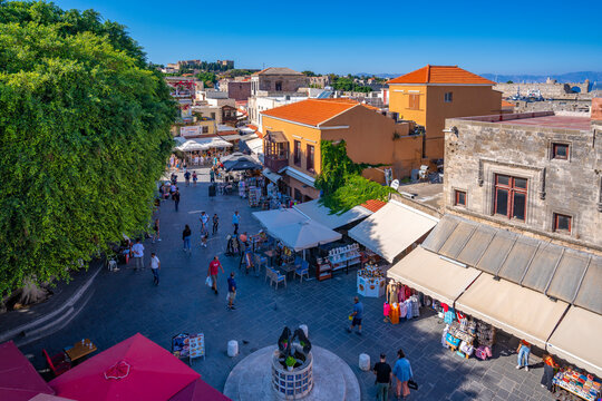 View of shops and cafes in Evreon Martyron (Jewish Martyrs Square), City of Rhodes, Rhodes, Dodecanese Islands, Greek Islands