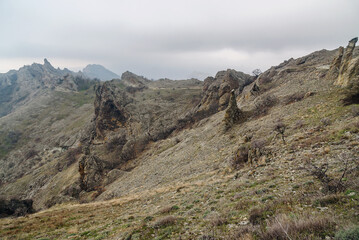 Fototapeta na wymiar Devil's fireplace rock and bizarre rocks in Dead city. Khoba-Tele Ridge of Karadag Reserve in spring. Crimea