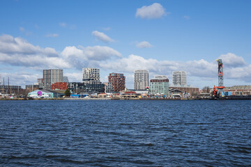 Panoramic view from the IJ river to NDSM neighborhood (Amsterdam-Noord borough), located on the former terrain NDSM-wharf, along the IJ river. AMSTERDAM, The NETHERLANDS.